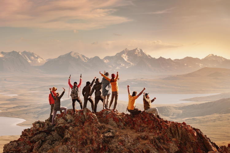 Group of Friends Cheer while on top a mountain